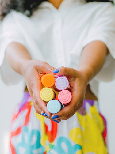 person holding vibrators with smile buttons