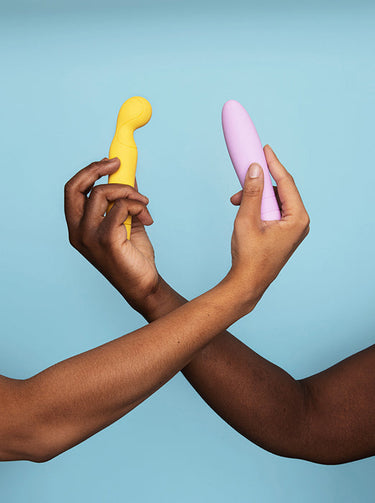 two hands holding an internal vibrator each