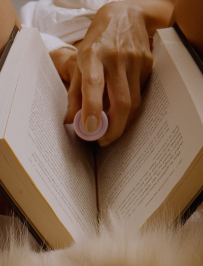 someone holding a vibrator in an open book