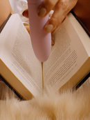 an open book with a vibrator being pushed between it