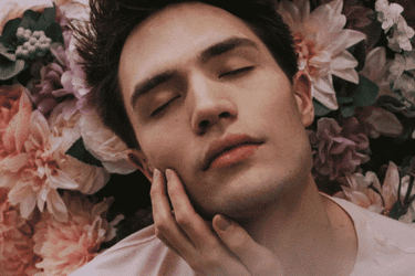 man in a bed of flowers