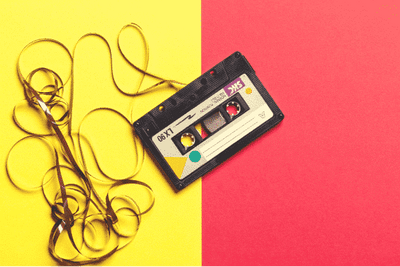 a tape cassette on a yellow and red background