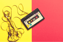 a tape cassette on a yellow and red background