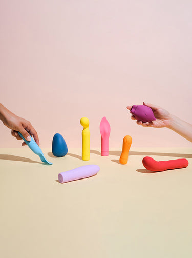 two hands choosing from a selection of Smile Makers' vibrators