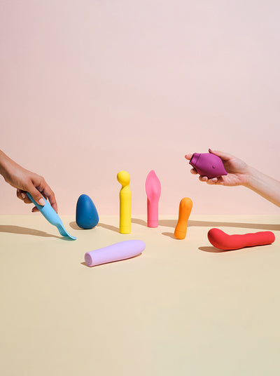 two hands choosing from a selection of Smile Makers' vibrators
