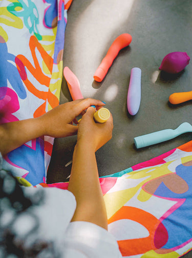 person sat with colorful vibrators. Photo by Annika Wolter