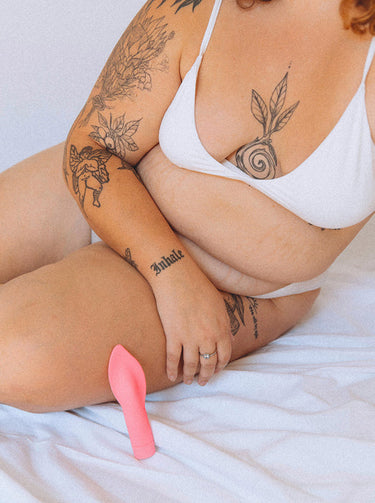 The Firefighter clitoral vibrator against a person's leg. Pic by Millie Brandon.