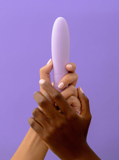 two hands holding a lilac vaginal vibrator by Smile Makers