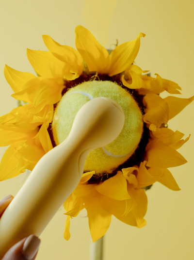 a yellow vibrator touching a sun flower
